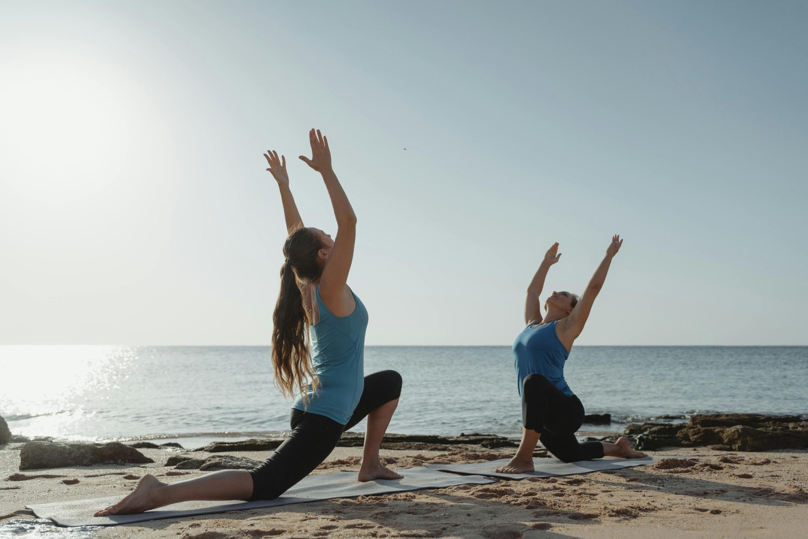 Woman doing yoga outdoors at sunrise